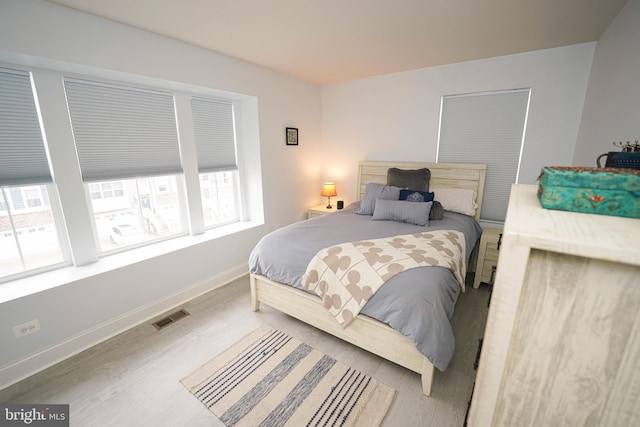 36063 Auburn Way, Millsboro, DE 19966 - bedroom featuring multiple windows, wood finished floors, and baseboards