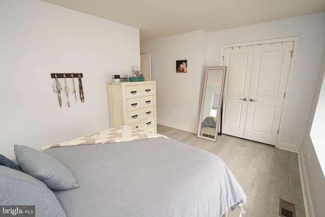 36063 Auburn Way, Millsboro, DE 19966 - bedroom with light wood-type flooring, a closet, and baseboards