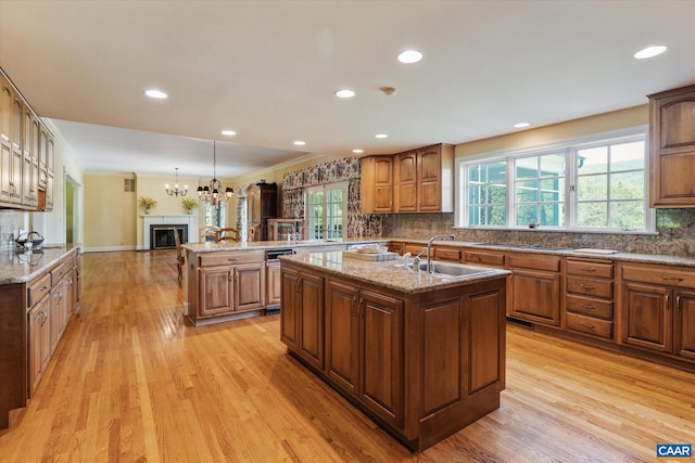 5190 Sugar Ridge Rd, Crozet, VA 22932 - kitchen featuring a sink, a center island with sink, light wood-style flooring, tasteful backsplash, and crown molding