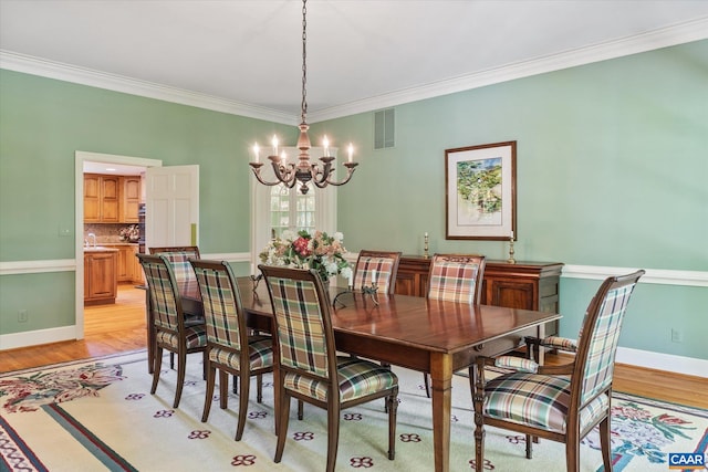 5190 Sugar Ridge Rd, Crozet, VA 22932 - dining space with a chandelier, crown molding, light wood-style floors, and baseboards