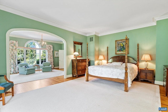 5190 Sugar Ridge Rd, Crozet, VA 22932 - bedroom featuring arched walkways, ornamental molding, wood finished floors, a chandelier, and baseboards