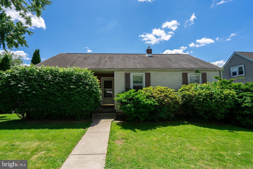 940 Marion St, Bethlehem, PA 18017 - view of front of house with a front yard and a chimney