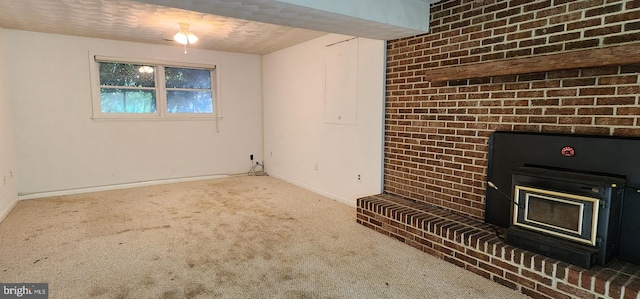 30120 Dudley Rd, Mechanicsville, MD 20659 - unfurnished living room featuring a wood stove, carpet, and baseboards