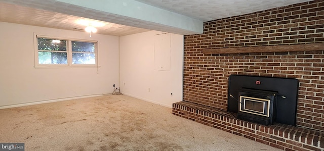 30120 Dudley Rd, Mechanicsville, MD 20659 - unfurnished living room featuring carpet, baseboards, a textured ceiling, and a wood stove