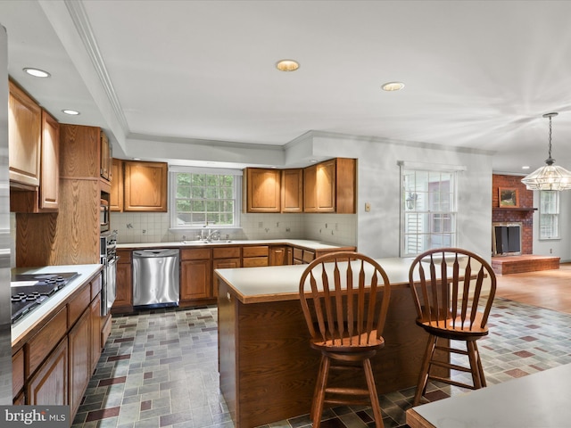 13124 S River Rd, Sumerduck, VA 22742 - kitchen with stainless steel appliances, brown cabinets, a kitchen breakfast bar, backsplash, and recessed lighting