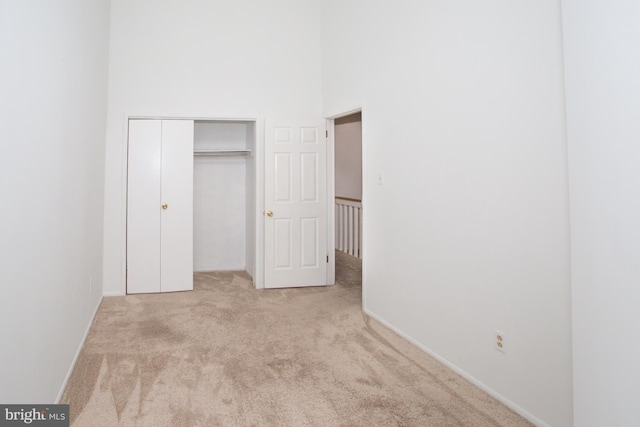 40 Ashley Dr, New Castle, DE 19720 - unfurnished bedroom with carpet floors, a towering ceiling, a closet, and baseboards