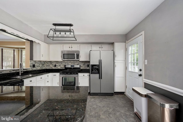 12329 Manchester Way, Woodbridge, VA 22192 - kitchen with appliances with stainless steel finishes, a sink, white cabinetry, backsplash, and baseboards