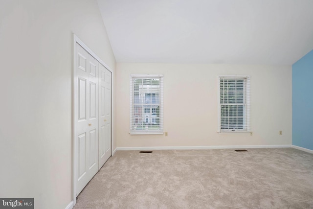 12329 Manchester Way, Woodbridge, VA 22192 - unfurnished bedroom featuring light colored carpet, baseboards, vaulted ceiling, and a closet
