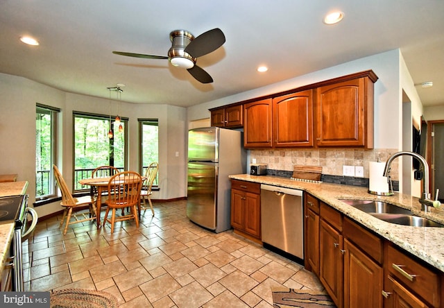 2415 Schaffer Rd, Pottstown, PA 19464 - kitchen featuring appliances with stainless steel finishes, a sink, a ceiling fan, baseboards, and tasteful backsplash