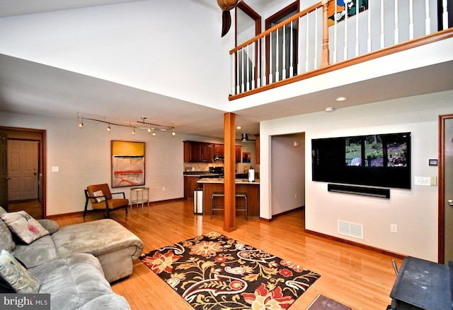 2415 Schaffer Rd, Pottstown, PA 19464 - living area featuring a towering ceiling, light wood finished floors, and baseboards