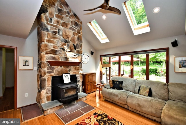 2415 Schaffer Rd, Pottstown, PA 19464 - living area with a wood stove, light wood-type flooring, a skylight, and high vaulted ceiling