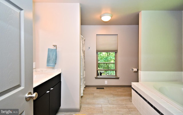 2415 Schaffer Rd, Pottstown, PA 19464 - bathroom with vanity, a garden tub, and baseboards