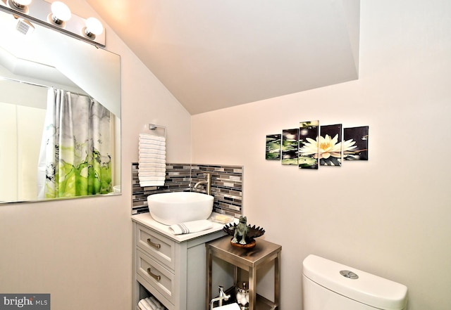 2415 Schaffer Rd, Pottstown, PA 19464 - bathroom with toilet, vanity, decorative backsplash, vaulted ceiling, and curtained shower