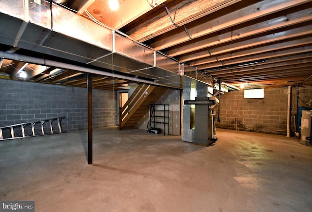 2415 Schaffer Rd, Pottstown, PA 19464 - unfinished below grade area featuring stairway, heating unit, and concrete block wall