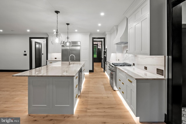 934 Chesterfield Rd, Annapolis, MD 21401 - kitchen with premium appliances, wall chimney range hood, tasteful backsplash, light wood finished floors, and recessed lighting