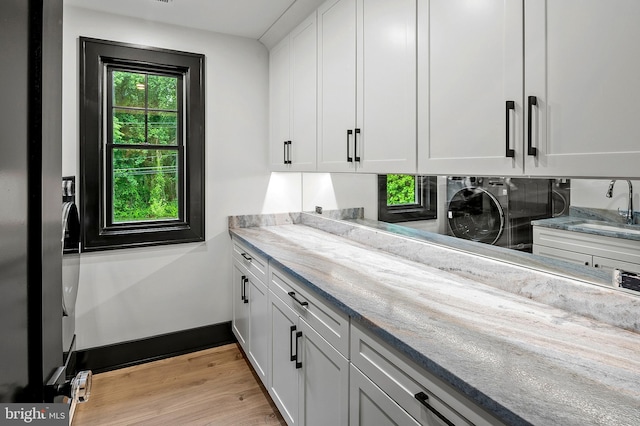 934 Chesterfield Rd, Annapolis, MD 21401 - kitchen with white cabinetry, light wood-type flooring, and light stone counters