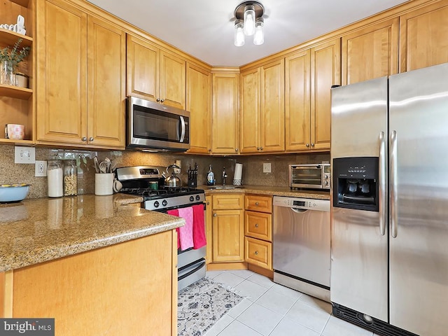 3721 S Hereford Ln, Philadelphia, PA 19114 - kitchen with stainless steel appliances, open shelves, light tile patterned floors, decorative backsplash, and light stone countertops