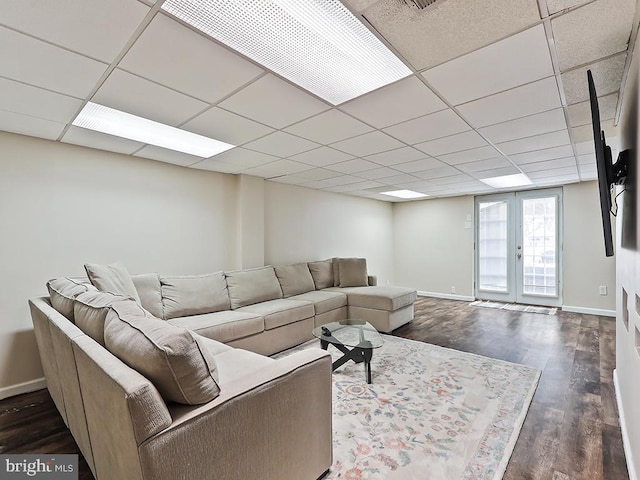 3721 S Hereford Ln, Philadelphia, PA 19114 - living area with dark wood finished floors, baseboards, a paneled ceiling, and french doors
