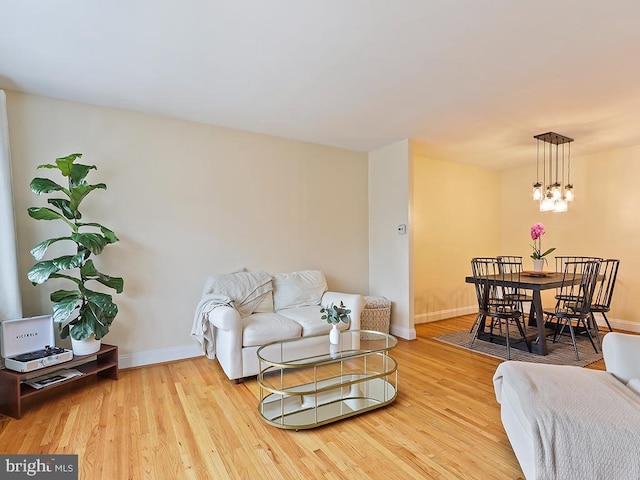 3721 S Hereford Ln, Philadelphia, PA 19114 - living area featuring baseboards, wood finished floors, and a chandelier