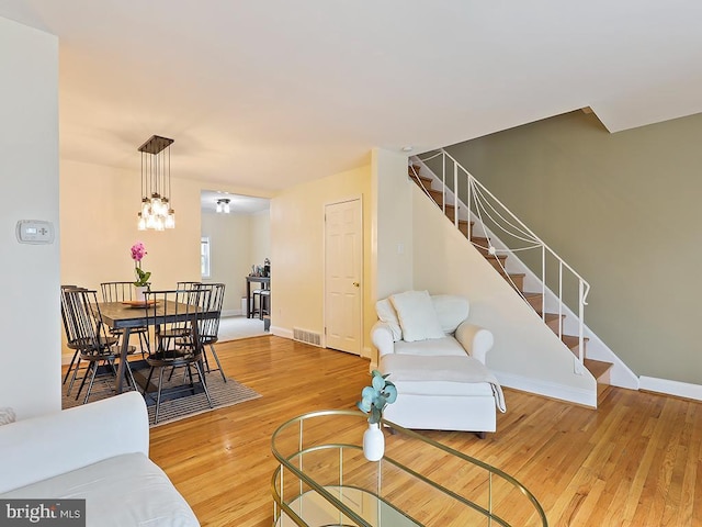 3721 S Hereford Ln, Philadelphia, PA 19114 - living room featuring stairs, light wood finished floors, and baseboards