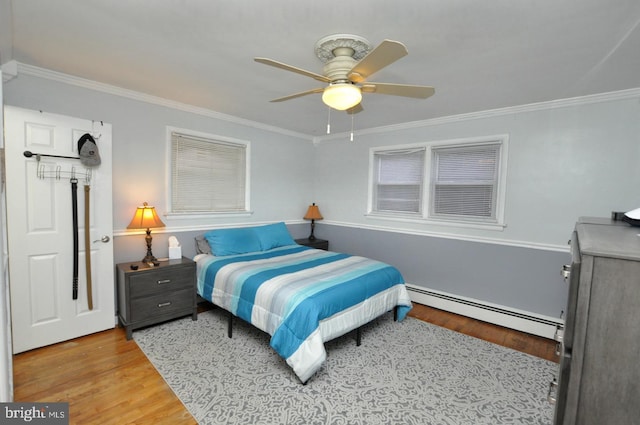 628 Mercer St, Cherry Hill, NJ 08002 - bedroom featuring a baseboard radiator, wood finished floors, ornamental molding, and ceiling fan