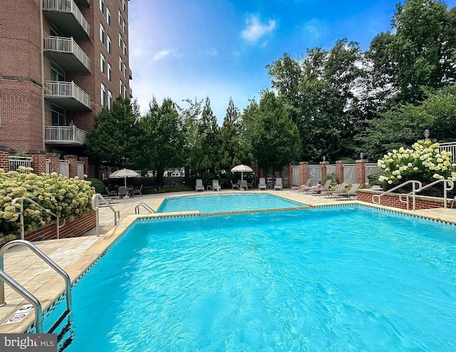 4490 Market Commons Dr Unit 302, Fairfax, VA 22033 - community pool with a patio and view of wooded area