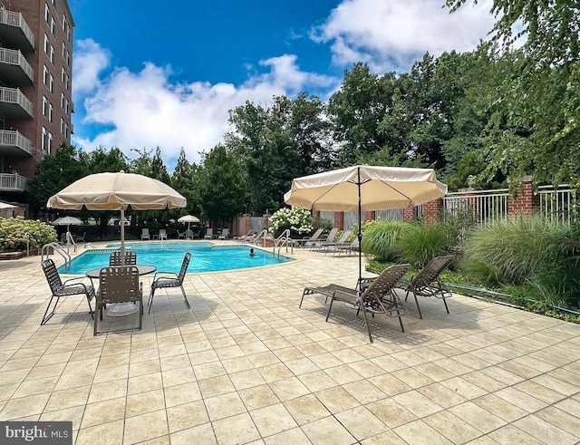 4490 Market Commons Dr Unit 302, Fairfax, VA 22033 - community pool with a patio area and view of wooded area