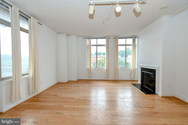 4490 Market Commons Dr Unit 302, Fairfax, VA 22033 - unfurnished living room featuring a fireplace, light wood-style floors, and baseboards
