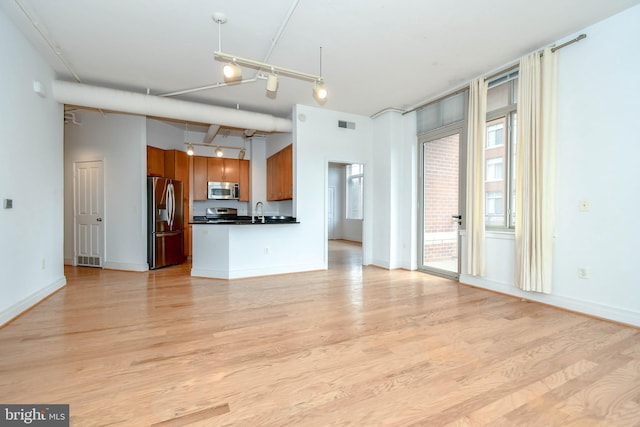 4490 Market Commons Dr Unit 302, Fairfax, VA 22033 - unfurnished living room with light wood-style floors, a sink, and baseboards