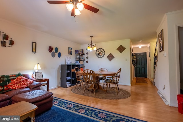 419 S Wyomissing Ave, Reading, PA 19607 - dining room featuring wood finished floors, ceiling fan, crown molding, baseboards, and a chandelier
