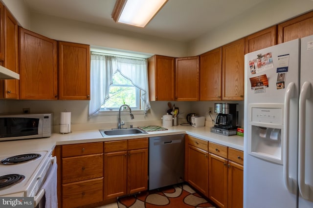 419 S Wyomissing Ave, Reading, PA 19607 - kitchen with white appliances, a sink, light countertops, and brown cabinets