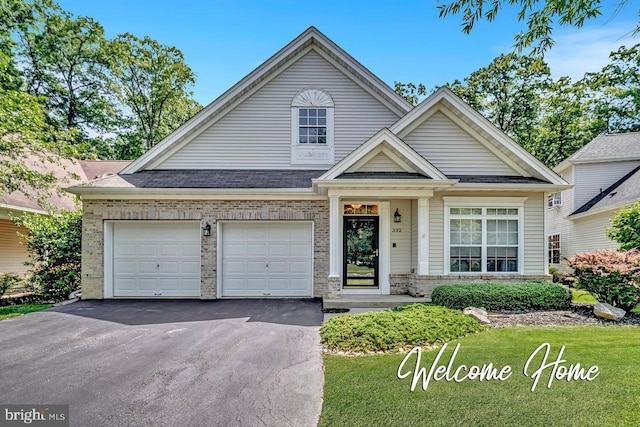 332 Blanketflower Ln, West Windsor, NJ 08550 - view of front of property with asphalt driveway, brick siding, a garage, and a front lawn