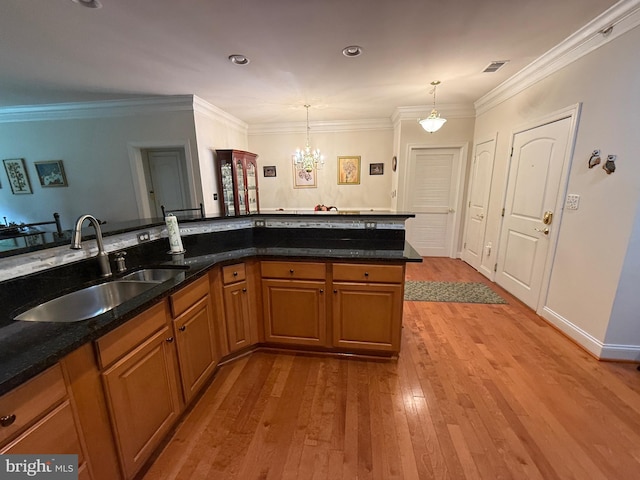 902 Macphail Woods Xing Unit 4F, Bel Air, MD 21015 - kitchen with a sink, hardwood / wood-style floors, brown cabinetry, a chandelier, and ornamental molding