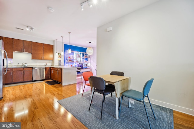 8005 13th St Unit 411, Silver Spring, MD 20910 - dining area featuring light wood-type flooring and baseboards
