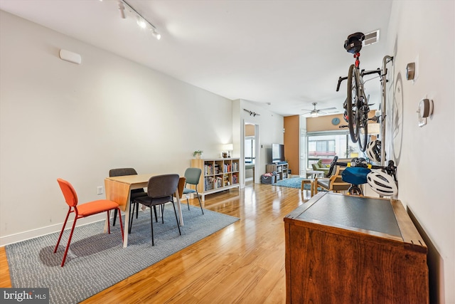 8005 13th St Unit 411, Silver Spring, MD 20910 - dining space featuring rail lighting, light wood finished floors, a ceiling fan, and baseboards