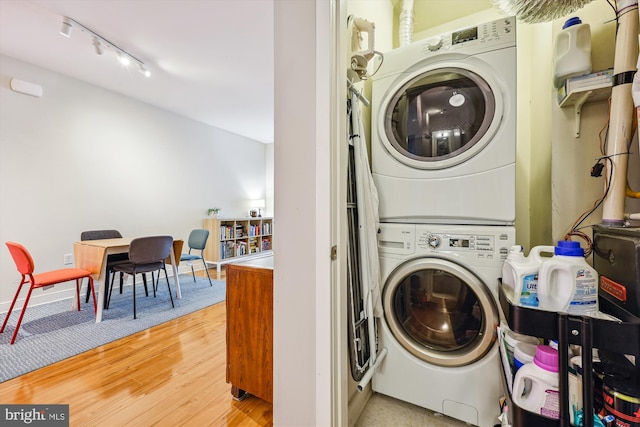 8005 13th St Unit 411, Silver Spring, MD 20910 - laundry area featuring stacked washer and clothes dryer, track lighting, and wood finished floors