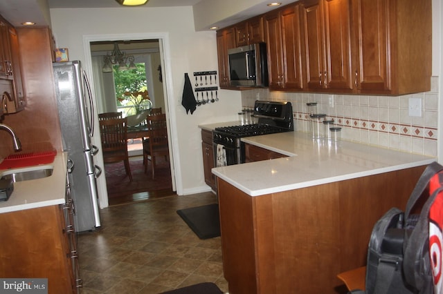 2404 Blue Valley Dr, Silver Spring, MD 20904 - kitchen featuring appliances with stainless steel finishes, decorative backsplash, a peninsula, and a sink