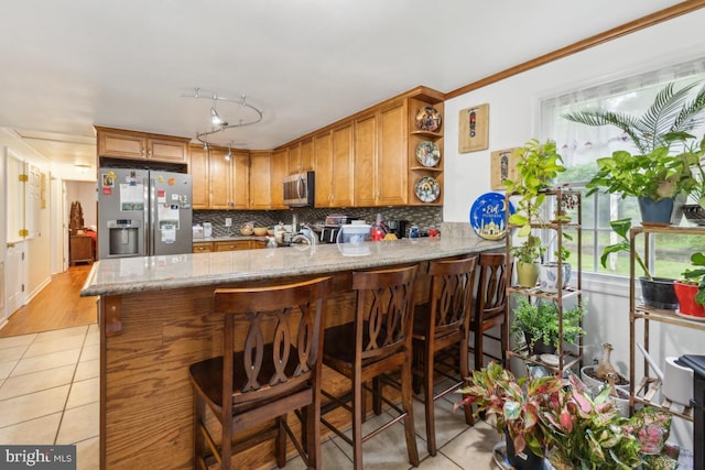 11617 Smithfield Rd, Manassas, VA 20112 - kitchen with stainless steel appliances, light tile patterned flooring, backsplash, open shelves, and a peninsula
