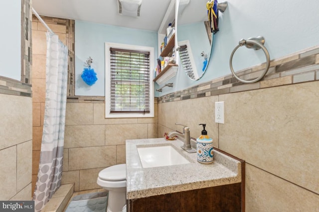 11617 Smithfield Rd, Manassas, VA 20112 - bathroom featuring tile walls, a tile shower, vanity, toilet, and wainscoting