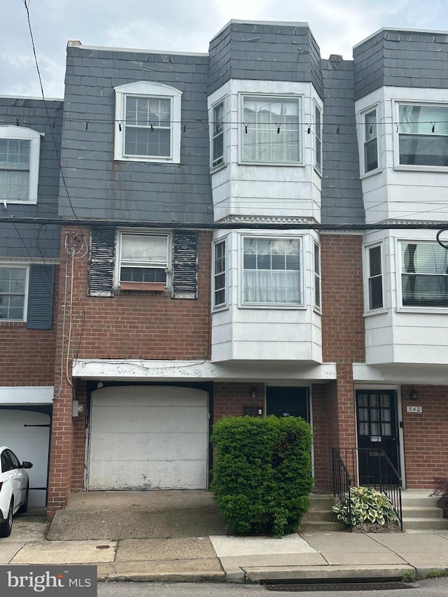 538 W Queen Ln, Philadelphia, PA 19144 - multi unit property featuring an attached garage, brick siding, and driveway