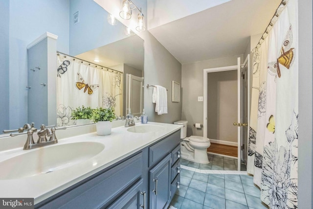 727 Hemlock Rd, Media, PA 19063 - full bathroom featuring double vanity, toilet, tile patterned flooring, and curtained shower