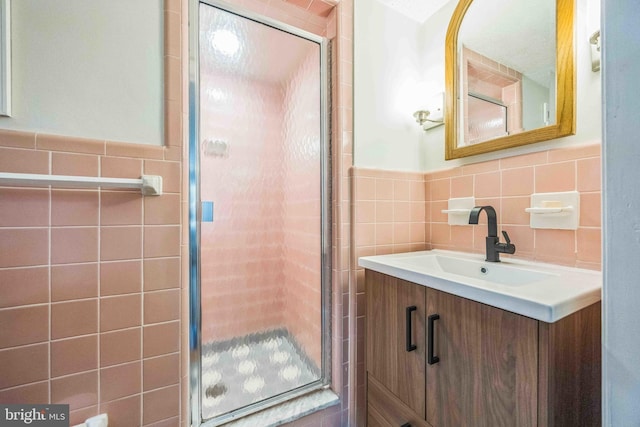 727 Hemlock Rd, Media, PA 19063 - full bathroom featuring tile walls, a stall shower, vanity, and wainscoting