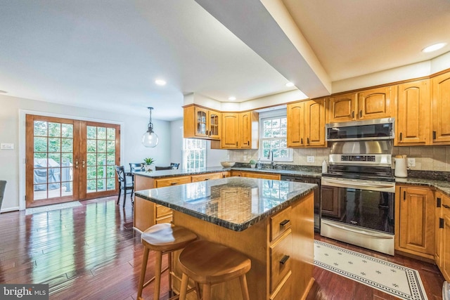 727 Hemlock Rd, Media, PA 19063 - kitchen with appliances with stainless steel finishes, a peninsula, dark wood finished floors, backsplash, and a sink
