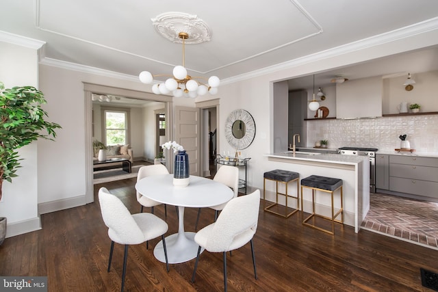 110 Varnum St NW, Washington, DC 20011 - dining room with a chandelier, crown molding, baseboards, and dark wood-type flooring