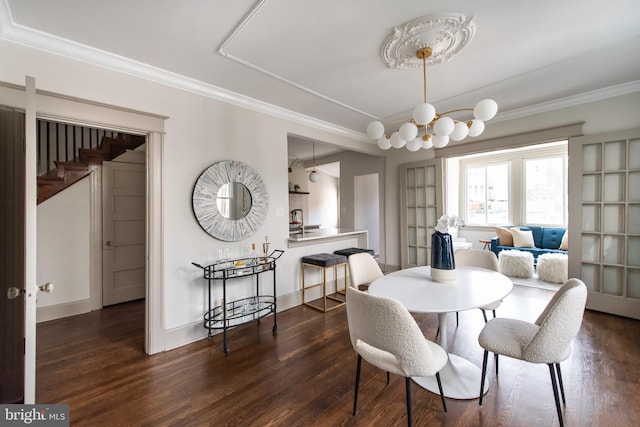 110 Varnum St NW, Washington, DC 20011 - dining space with wood finished floors, a chandelier, ornamental molding, and baseboards