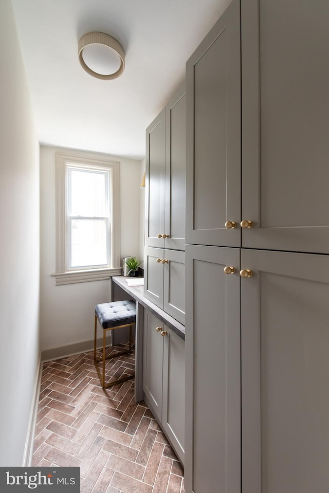 110 Varnum St NW, Washington, DC 20011 - laundry room featuring brick floors and baseboards
