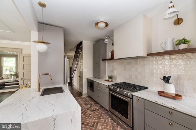 110 Varnum St NW, Washington, DC 20011 - kitchen featuring gray cabinets, appliances with stainless steel finishes, a sink, and brick flooring