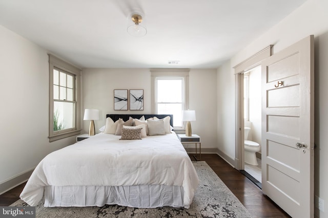 110 Varnum St NW, Washington, DC 20011 - bedroom with dark wood-type flooring, baseboards, and ensuite bath