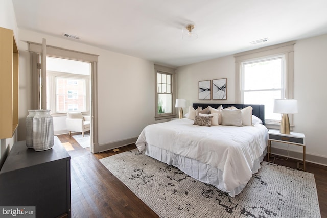 110 Varnum St NW, Washington, DC 20011 - bedroom with dark wood-style flooring, multiple windows, and baseboards
