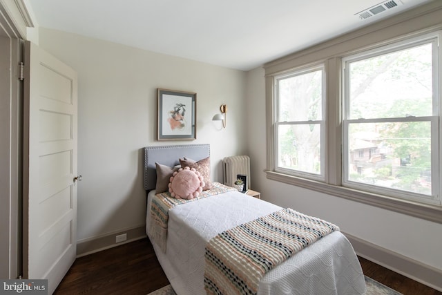 110 Varnum St NW, Washington, DC 20011 - bedroom featuring radiator heating unit, dark wood-type flooring, and baseboards